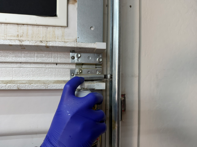 Lubricating a garage door with silicone lubricant spray
